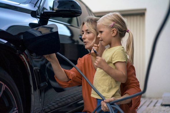 Mor og barn som lader elbil