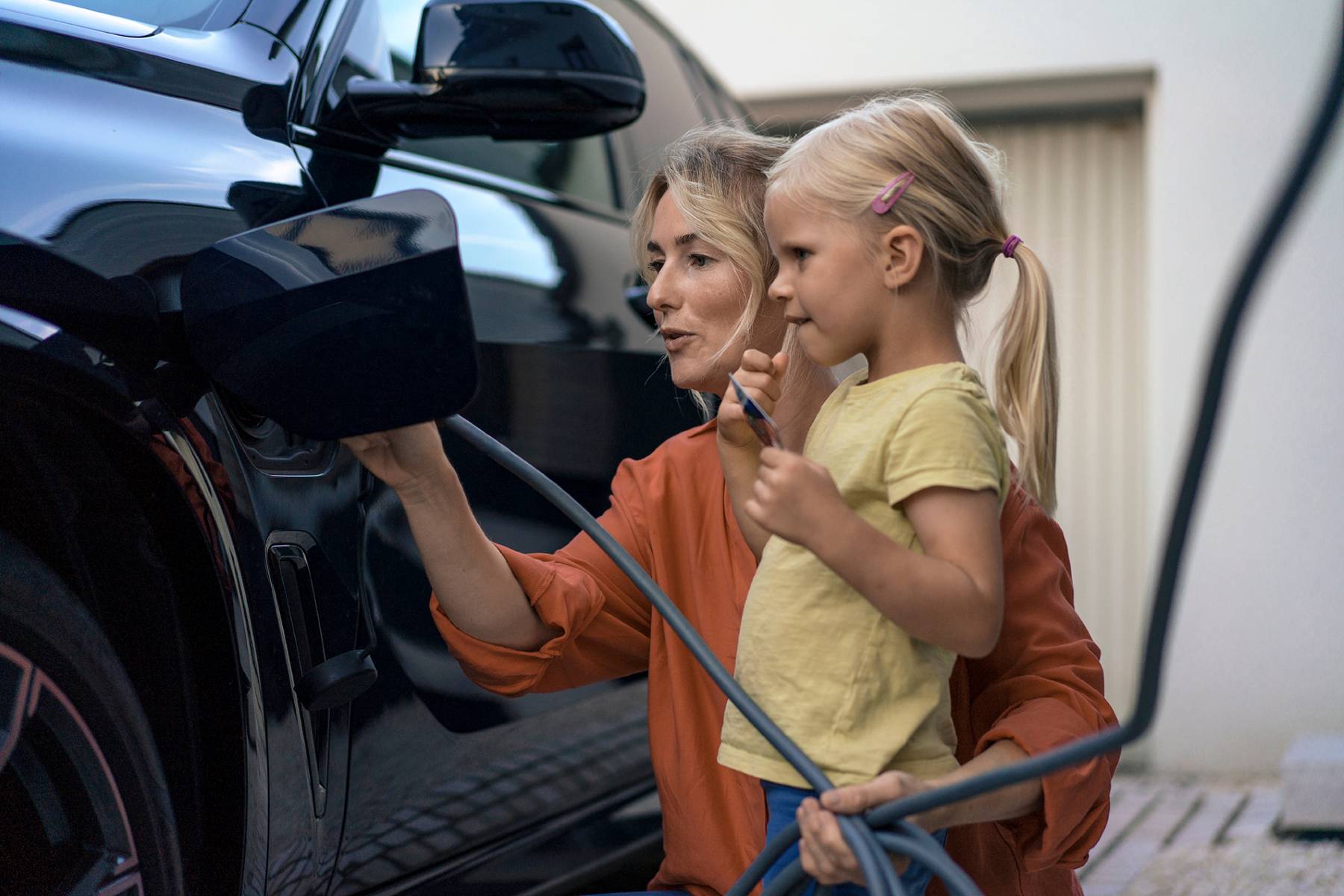 Mor og barn som lader elbil